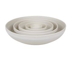 four white bowls stacked on top of each other