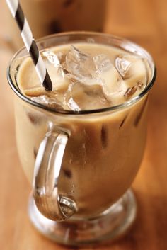 two glasses of iced coffee with straws on the top and ice in the bottom