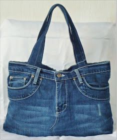 a denim bag with a dog bone on it hanging from a hook in a wall