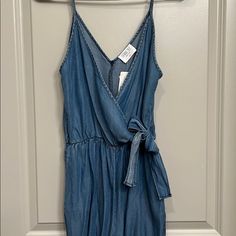 Brand New Never Been Worn Adorable Jean Jumpsuit With Side Tie Bow! Sleeveless Blue Denim Jumpsuit For Day Out, Casual V-neck Denim Jumpsuit For Summer, Casual Blue Denim Jumpsuit With V-neck, Casual Blue Denim Jumpsuit V-neck, Sleeveless Denim Jumpsuit For Day Out, Fitted V-neck Denim Jumpsuit For Summer, Casual Denim Jumpsuits And Rompers For Vacation, Summer Fitted Jumpsuits And Rompers With Tie Waist, Fitted Summer Jumpsuits And Rompers With Tie Waist