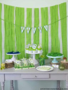 a table topped with green and white desserts