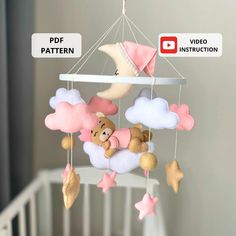 a baby crib mobile with teddy bears and stars hanging from it's sides