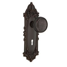 an antique style door handle with a round knob