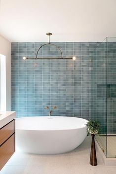 a bathroom with a large bathtub next to a walk in shower