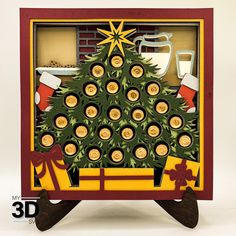 a christmas tree made out of wine corks in a wooden frame with an ornament on top