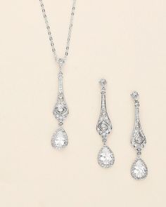 Complete your bridal look with this stunning wedding jewelry set. The sparkling cubic zirconia stones delicately accentuate the bride's natural beauty, adding a touch of elegance and glamor. Featuring an art deco style design, this bridal jewelry set features CZ teardrops accented with a filigree pattern. DETAILS * High quality cubic zirconia.  * Earrings measure 2 inches long. * Necklace is adjustable from 16 inches to 18 inches long, pendant (including bail) measures 2 inches. * Perfect for brides, bridesmaids, prom, or any special occasion. Optional custom cards available for gift giving! * Optional bracelet measures 7 inches long. * Finish: silver, gold or rose gold. * Hypoallergenic, lead-free & nickel-free. SHIPPING * Leaves our facility within 1-3 business days. * Shipping upgrades Wedding Diamond Bridal Earrings With Sparkling Stones, Diamond Bridal Earrings With Sparkling Stones, Brilliant Cut Teardrop Bridal Earrings For Wedding, Teardrop Brilliant Cut Bridal Earrings, Brilliant Cut Teardrop Bridal Earrings, Diamond White Bridal Earrings With Brilliant Cut, Diamond White Brilliant Cut Bridal Earrings, Classic Cubic Zirconia Bridal Earrings For Wedding, Dazzling Diamond-accented Jewelry Sets For Wedding