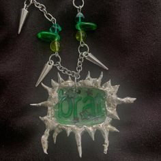 Please note there are two options for this necklace. You can choose a simple chain with no beads, so it will just be the brat charm. The second option is to get the pendant with green beads and spikes on the chain. You can see the difference in the photos. Message me if you have any questions! Made from lead free solder. (Shrinky dink made by @sweet.fea.studios on IG) Green Nickel-free Pendant Charm Necklace, Green Metal Pendant Charm Necklaces, Green Metal Necklace With Charms, Green Metal Necklaces With Charms, Soft Solder, Soldered Pendants, Wood River, Shrinky Dink, Simple Chain