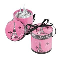 two pink tins with the eiffel tower on them, one is wrapped in black ribbon