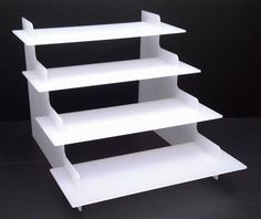 a white shelf sitting on top of a black table