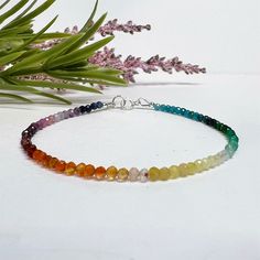 This colorful, dainty beaded bracelet is made with tiny 2mm faceted round gemstone beads in a rainbow of gorgeous colors! The gemstones are arranged in an ombre shaded pattern, and include a variety of semi-precious stones and crystals carefully strung on flexible aluminum wire. Perfect for celebrating or showing your support for Pride, or just for those who love rainbows and colorful jewelry! This piece can also be made as an anklet or necklace, just select the length you prefer or message us w Dainty Faceted Beaded Bracelets, Rainbow Beaded Bracelets With Faceted Beads For Gift, Rainbow Faceted Beads Bracelet As Gift, Rainbow Faceted Round Beads Bracelets, Spiritual Multicolor Faceted Beaded Bracelets, Rainbow Gemstone Beaded Round Bracelets, Rainbow Gemstone Beads Bracelet With Round Beads, Rainbow Gemstone Beads Bracelets, Rainbow Crystal Bracelet With Colorful Round Beads