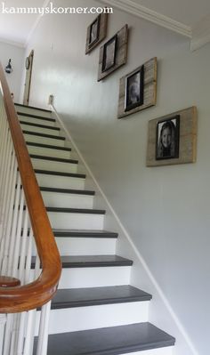 stairs leading up to the second floor in a house with pictures on the wall above them