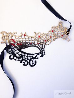 Masquerade Ball Masks Custom made and embellished to match your formal masquerade Party dress or costume. Intricately designed in the half face shape. All Masks come with either matching Ribbons or Stretched Lace. Base Material - Embroidered Lace Mask. All Masks come with either matching Ribbons or Stretched Lace. You may leave a note during checkout if you have a preference. Mask is available in left eye or right eye covered mask. You can leave a note during check out if you have a preference. Handmade Fantasy Masquerade Mask For Costume Party, Black Masquerade Mask For Halloween Gift, Adjustable Mask For Masquerade, Adjustable Eye Masquerade Mask, Adjustable Masquerade Mask, Adjustable Eye Mask For Masquerade, Gold Adjustable Masquerade Mask, Black Masks For Halloween Gift, Black Halloween Masks As Gifts