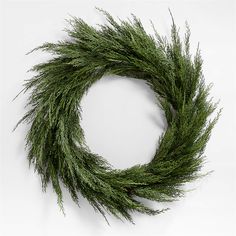 a close up of a green wreath on a white background