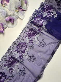 The purple lace features a soft, delicate texture that exudes lightness and elegance. Its design is adorned with intricate floral patterns, where the petals are crafted with meticulous detail. Scattered white leaves provide a beautiful contrast, highlighting the overall sophistication of the lace. Along the edge, there's a scalloped trim with an openwork pattern, adding a finishing touch and enhancing the lace's refined appearance. This listing is for 1 yard  Width:6.5 inch = 17 cm The lace's re Purple Embroidered Fabric With Border For Wedding, Purple Wedding Embroidered Fabric With Embroidered Border, Purple Lace Embroidered Fabric, Bra Making, Sewing Lingerie, White Leaves, Bleu Violet, Embroidered Tulle, Scalloped Trim