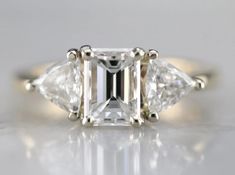 an engagement ring with three pear shaped diamonds