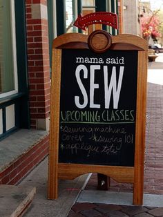 a sign that says sew upcoming classes on the sidewalk in front of a store