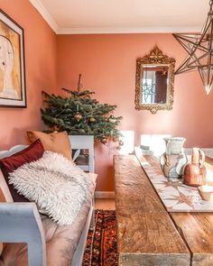 a living room with a christmas tree in the corner and other decorations on the table