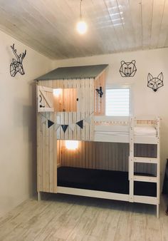 a bunk bed in a room with wooden walls