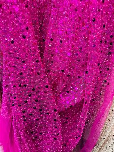 pink sequins on fabric with white background