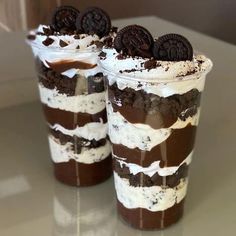 two dessert cups filled with oreo cookies and cream