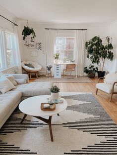 a living room filled with furniture and plants