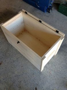 an empty wooden box sitting on the ground