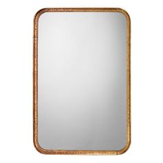 a gold framed mirror sitting on top of a white wall