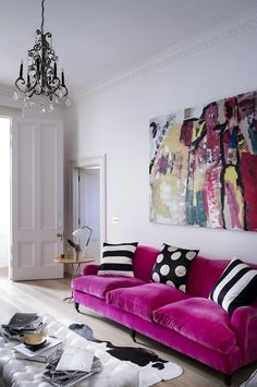 a living room filled with furniture and a chandelier