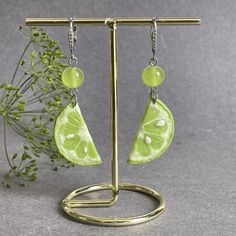 Welcome to our delightful collection of Lime Earrings! If you're a fan of all things citrusy and fun, then these lime-themed earrings are the perfect addition to your jewelry collection. Each pair is meticulously handcrafted with love and care using high-quality materials, ensuring you'll have a piece of wearable art that will brighten up your day. These handmade earrings are designed to bring joy! Earrings length 6,5 сm (2.5 inches). The earrings are suspended on zirconium links and rhodium plated Our Lime Slice Earrings are a real show-stopper. These eye-catching dangle earrings  a realistic slice of lime made from polymer clay. The vibrant green hue of the lime slice exudes a fresh and zesty vibe that is sure to draw attention and compliments wherever you go. The attention to detail is Cheap Lime Green Earrings For Gift, Coconut Earrings, Coconut Jewelry, Funky Fruit, Summer Pendant, Lime Slice, Funny Jewelry, Fruit Necklace, Food Charms