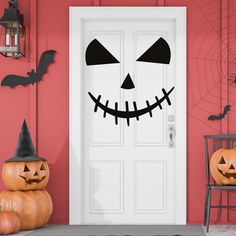 a front door decorated for halloween with pumpkins and jack - o'- lanterns