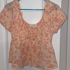 Coral Colored Cropped Peplum Top. Breathable Material. Size L. Never Worn. Tags Attached. Cute Apricot Tops For Spring, Cute Apricot Top For Spring, Peach Floral Print Summer Blouse, Fitted Floral Print Peach Tops, Pink Floral Crop Top, Fitted Peach Floral Print Tops, Bohemian Pink Crop Top, Fitted Feminine Pink Peplum Top, Pink Floral Patchwork Cotton Top