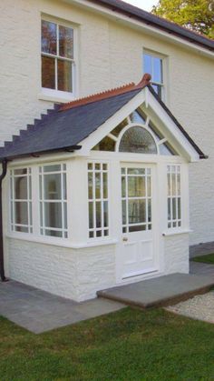 a white house with a black roof and windows