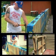 a man is building a fence out of pallets and other things he's working on