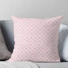 a pink pillow sitting on top of a couch