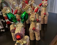 some wine corks are decorated with christmas decorations