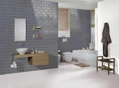 a bathroom with white brick walls and wood flooring is shown in this image, there are two sinks on either side of the bathtub