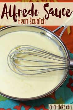 the ingredients for alfredo sauce in a metal bowl on a colorful tablecloth with text overlay