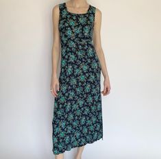 "Product Details: Adorable vintage blue floral dress. Fabric does stretch, can different sizes depending on how baggy you want the fit. Perfect picnic or summertime dress! Lays about mid-calf. Super lightweight and airy.  Brand: Unknown Material: Unknown Marked Size: Unknown Measurements: Bust: 16.5\" Waist: 16\" Height: 16.5\" Length: 50\" Amazing condition. Model: 5'9\" All sales are final." Blue Midi Dress With Ditsy Floral Print For Summer, Blue Maxi Dress With Ditsy Floral Print For Summer, Blue Sleeveless Midi Dress With Ditsy Floral Print, Blue Ditsy Floral Midi Dress For Beach, Blue Midi Dress With Ditsy Floral Print For Beach, Blue Ditsy Floral Print Maxi Dress For Garden Party, Bohemian Blue Midi Dress With Ditsy Floral Print, Casual Sleeveless Blue Floral Dress, Vintage Blue Floral Print Midi Dress