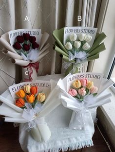 three bouquets of flowers sitting on top of a table