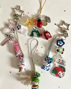 many charms are hanging on a white surface