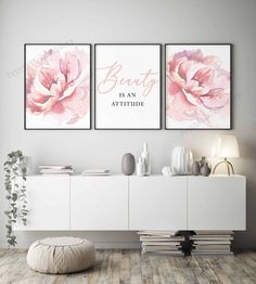 two pink flowers with the words beauty is an attitude on them in front of a white cabinet