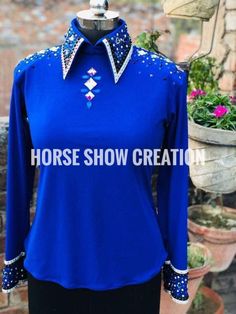 the horse show shirt is blue and has silver sequins on it's collar