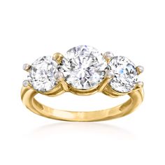 three stone diamond ring in yellow gold with diamonds on the sides and four round stones at the top