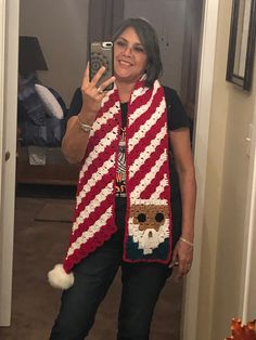 a woman taking a selfie in the mirror wearing a red and white striped scarf