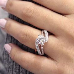 a woman's hand with a diamond ring on top of her finger and an engagement band