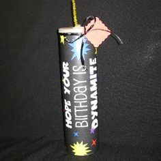 a birthday candle with a pink flamingo sticking out of it's side on a black background