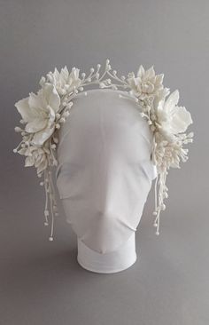 a white headpiece with flowers on it