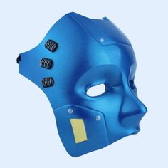 a blue mask with holes in the middle and yellow stickers on it's side