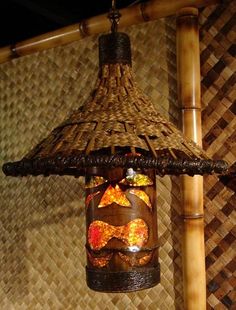 a bird feeder hanging from a bamboo roof