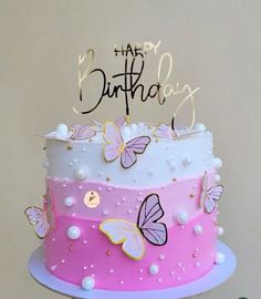 a birthday cake with butterflies on it and the words happy birthday written in gold lettering